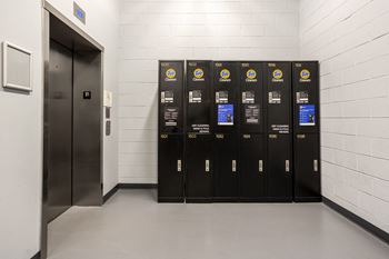 a row of lockers in a white room with a door